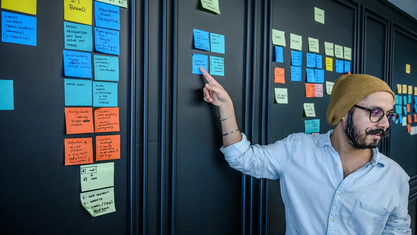 Team reviewing mobile product journey map on wall